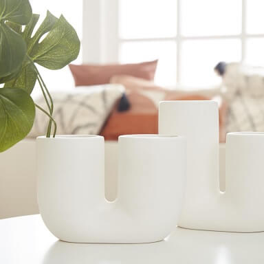 Zwei weise Porzellan-Vasen in U-Form, dekoriert mit einigen großen Blättern.